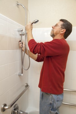 plumber in Lathrop CA installs a shower head